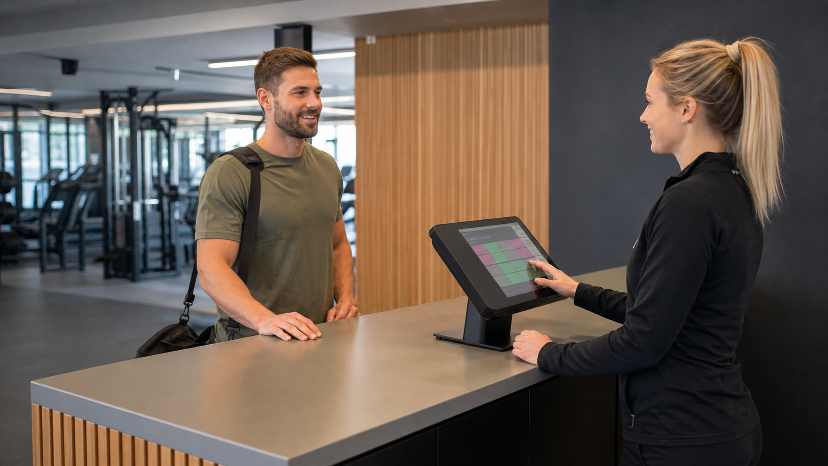 gym membership software UK used by a receptionist at a fitness studio